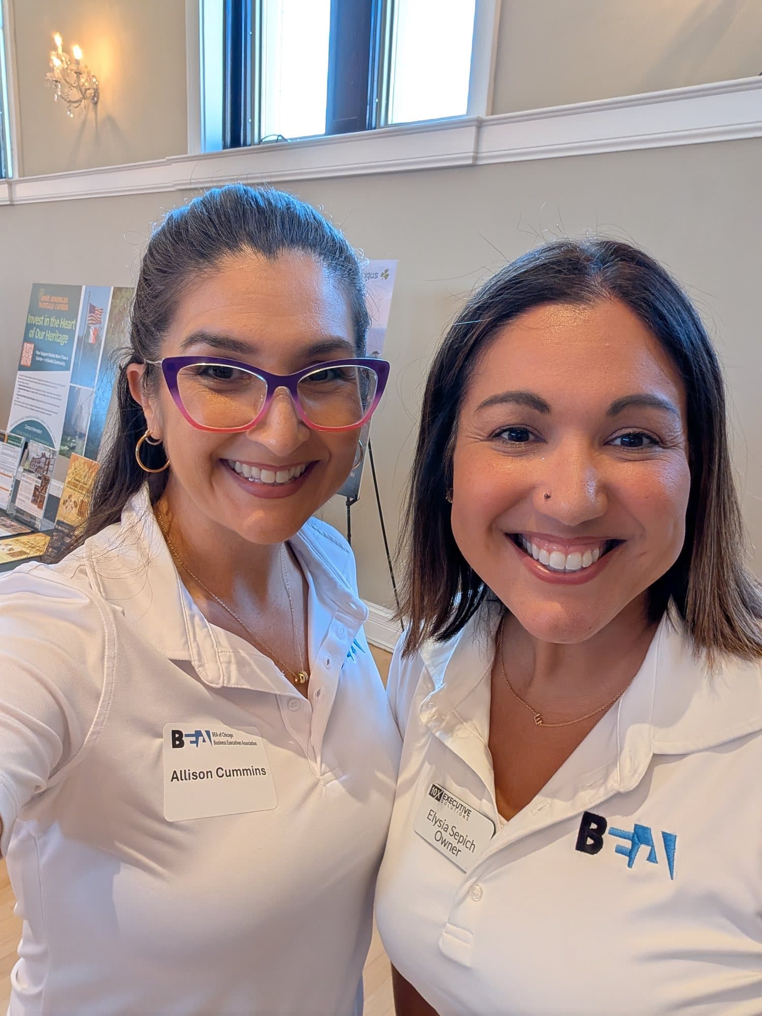 Two members in white polos with the BEA logo